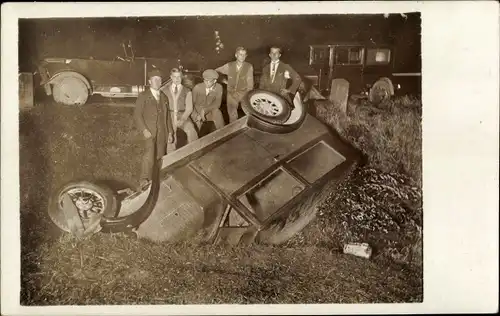 Foto Ak Verkehrsunfall, Automobil im Straßengraben, junge Männer