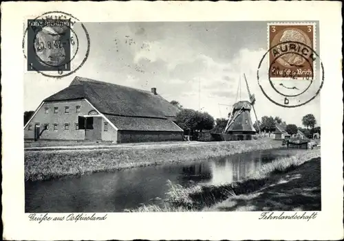 Ak Ostfriesland, Fehnlandschaft, Windmühle am Kanal, Reetdachhaus