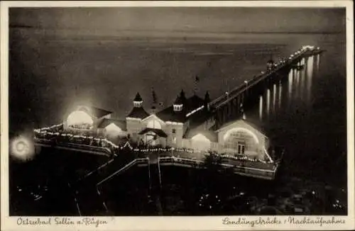 Ak Ostseebad Sellin auf Rügen, Landungsbrücke, Nachtaufnahme