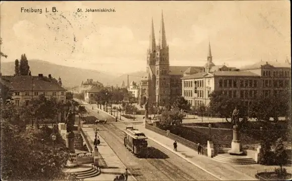 Ak Freiburg im Breisgau, St. Johanniskirche, Straßenbahn