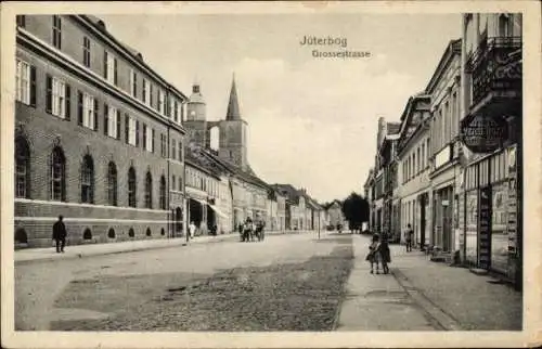 Ak Jüterbog, Großestraße mit Kirche St. Nicolai, Pferdewagen, Geschäfte