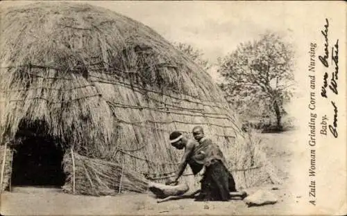 Ak Südafrika, Frau mahlt Getreide, Baby auf dem Rücken