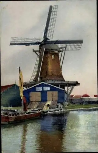 Ak Zaandam Nordholland, Windmühle am Ufer, Boot
