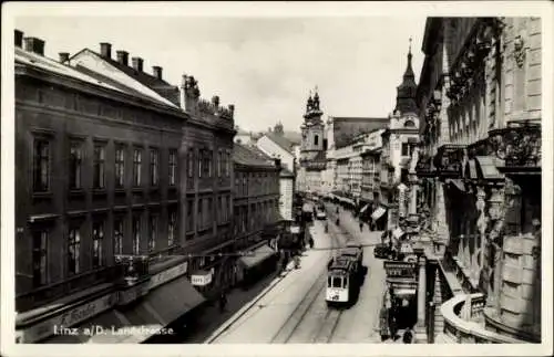 Ak Linz Donau in Oberösterreich, Partie in der Landstraße, Straßenbahn, Geschäfte, F. Forster, Cafe