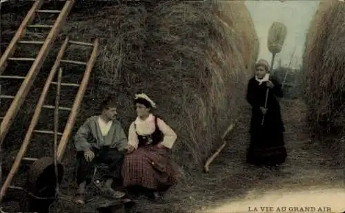 Ak Liebespaar an einem großen Heuhaufen