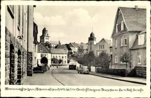 Ak Meinerzhagen im Sauerland, Straße durch den Ort, Ev. Kirche, Kath. Kirche