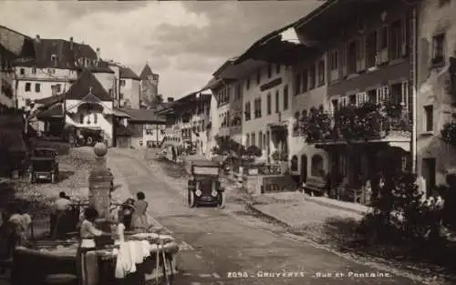 Ak Gruyères Kanton Freiburg Schweiz, Straße, Fontaine