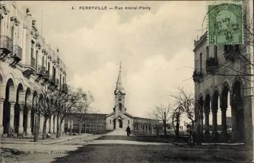 Ak Ferryville Tunesien, Rue Amiral Ponty, Straßenpartie mit Blick auf Kirche