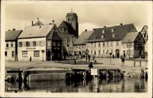 Ak Wolgast in Vorpommern, Partie am Ufer, Konsum, Kirchturm