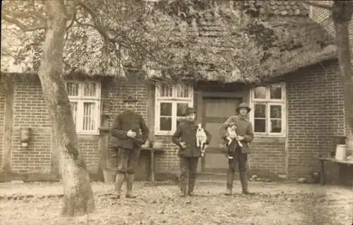 Foto Ak Bergen in der Lüneburger Heide, Männer vor einem Haus mit Reetdach