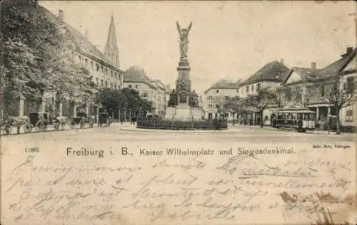 Ak Freiburg im Breisgau, Kaiser Wilhelmplatz, Siegesdenkmal, Straßenbahn