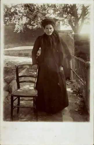 Foto Ak Frau in schwarzem Kleid, Porträt, Stuhl, Baum