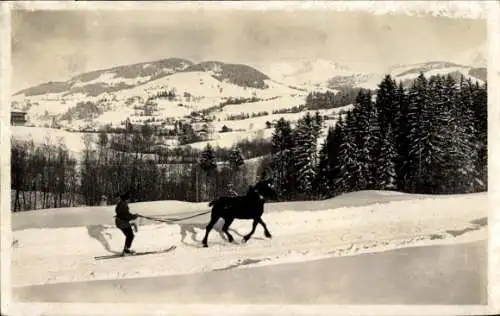 Ak Megève Haute Savoie, Ski djoering, Skifahrer lässt sich von Pferd ziehen