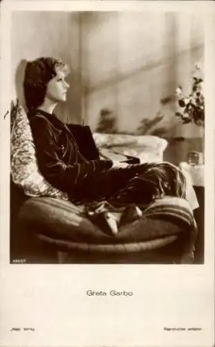 Ak Schauspielerin Greta Garbo, Sitzportrait auf einem Sofa, Ross Verlag 4961/1