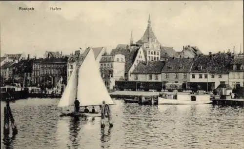 Ak Rostock in Mecklenburg, Hafen, Segelboot, Güterwagons, Häuserfassaden