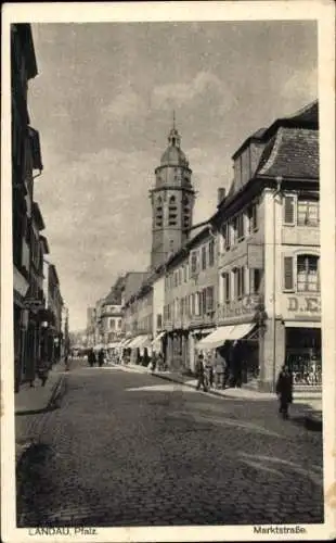 Ak Landau i.d. Pfalz, Blick in die Marktstraße mit Geschäften und Kirchturm