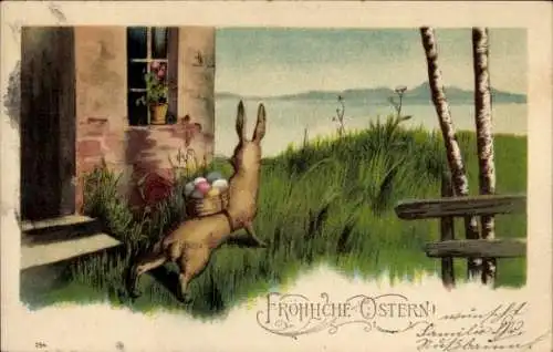 Ak Frohe Ostern, Osterhase mit Osterkorb am Haus