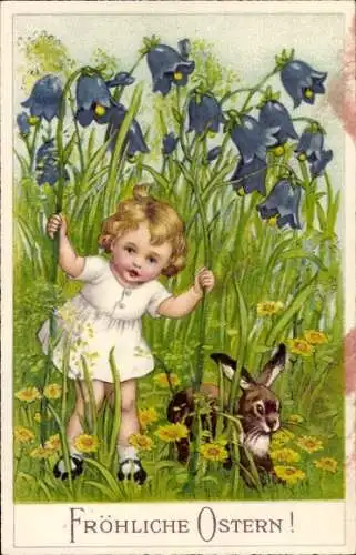 Ak Frohe Ostern, Mädchen mit einem Hasen auf Wiese, Blumen