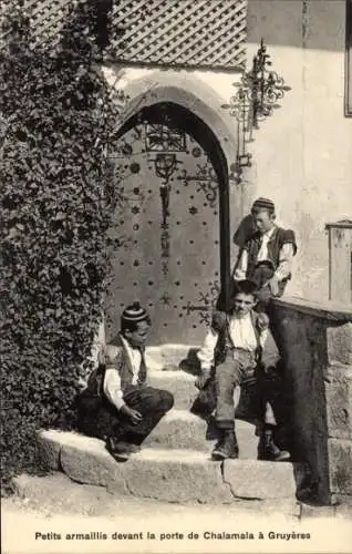 Ak Gruyères Kanton Freiburg Schweiz, Petits armaillis devant la porte de Chalamala