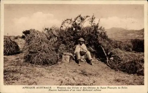 Ak Afrique Australe, Pauvre habitation d'um vieil Hottentot infirme, Eingeborene vor einer Hütte