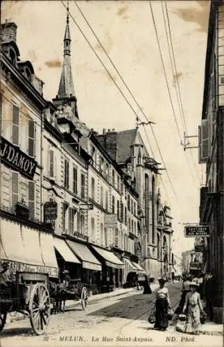 Ak Melun Seine et Marne, Rue Saint Aspais, Geschäfte, Kutsche, Oberleitungen