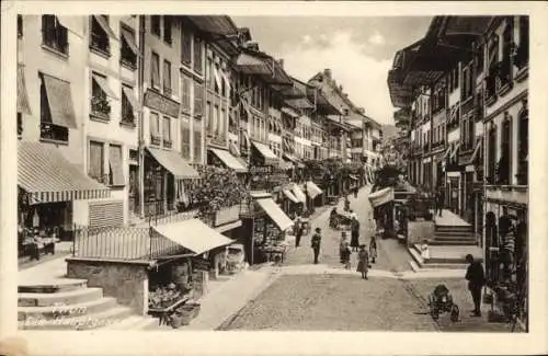 Ak Thun Kanton Bern, Die Hauptgasse mit Passanten und Geschäften