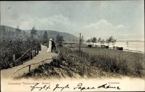 Ak Ostseebad Timmendorfer Strand, Promenade, zwei Personen, Bäume, Häuser