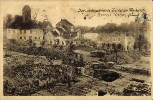 Ak Domnowo Domnau Ostpreußen, niedergebranntes Viertel, Marktplatz, Ruinen, historische Postkarte