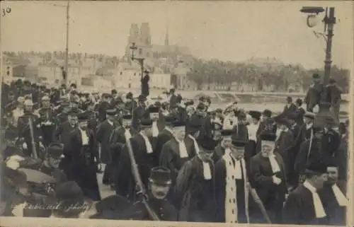 Ak Orléans Loiret, Prozession mit vielen Menschen in schwarzen Anzügen, Kirchen im Hintergrund