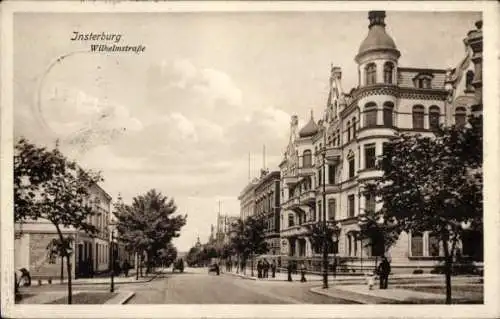 Ak Tschernjachowsk Insterburg Ostpreußen, Wilhelmstraße,  Gebäude, Straßenansicht, Himmel, Bäume
