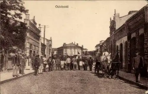 Ak Odobesti Rumänien, Strasse in   Gebäude, Personen, Pferd und Wagen, Friseursalon