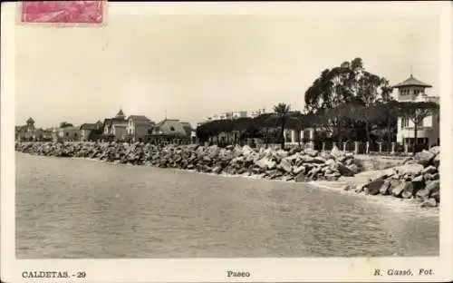 Ak Caldetas Caldes d’Estrac Katalonien Spanien, , Ansicht der Uferpromenade, Steine und Gebäud...
