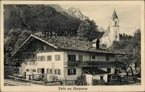 Ak Obergrainau Grainau in Oberbayern, Haus mit Holzveranda, Kirche im Hintergrund, Berge