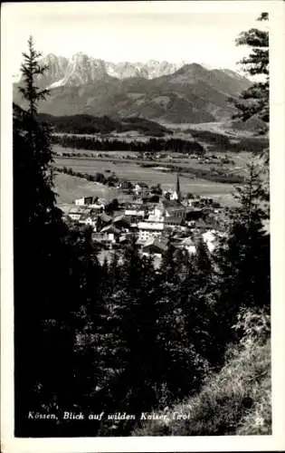 Ak Kössen in Tirol,  Blick auf wilden Kaiser, Berge, Dorf, Kirche, Bäume