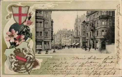 Präge Wappen Passepartout Ak Freiburg im Breisgau, Straßenpartie, Geschäfte
