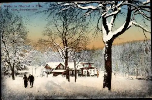 Ak Oberhof im Thüringer Wald, Winterlandschaft, schneebedeckte Bäume, Häuser im Schnee, zwei Pers