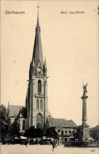 Ak Oberhausen im Ruhrgebiet, Herz Jesu-Kirche, hoher Kirchturm, Monument davor, Bäume,  