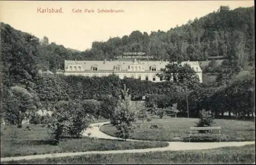Ak Karlsbad in Baden, Café Park Schönbrunn, parkähnliche Gartenanlage, Gebäude im Hintergrund