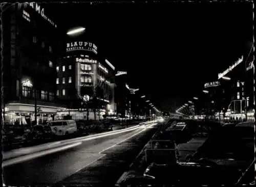 Ak Berlin Charlottenburg, Nachtaufnahme, Kurfürstendamm, beleuchtete Gebäude, Straße