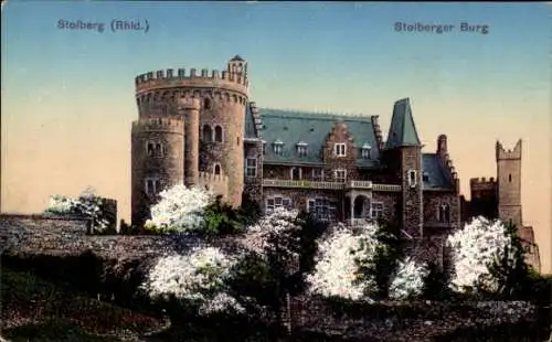 Ak Stolberg im Rheinland, Stolberger Burg, mittelalterlicher Stil, blühende Bäume im Vordergrund