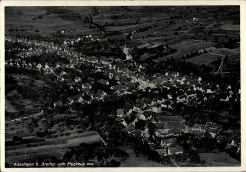 Ak Wössingen Walzbachtal in Baden, Luftaufnahme von Wössingen, Dorf mit vielen Dächern, Kirche si