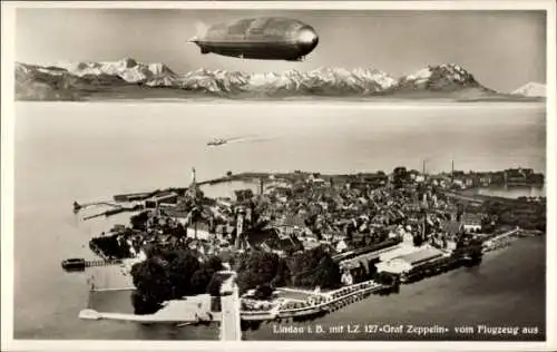 Ak Lindau am Bodensee Schwaben, Luftaufnahme von  Zeppelin, Berge im Hintergrund