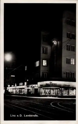 Ak Linz an der Donau Oberösterreich, Nachtaufnahme, Geschäfte, Werbung, Landstraße