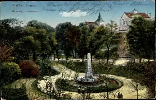 Ak Bielany Kraków Krakau Polen, Parkanlage mit Denkmal, Bäume, Gebäude im Hintergrund, farbige 