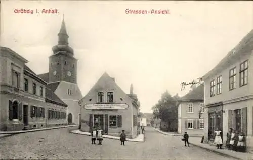 Ak Gröbzig in Anhalt, Straßenpartie, Kirche, Geschäftshaus