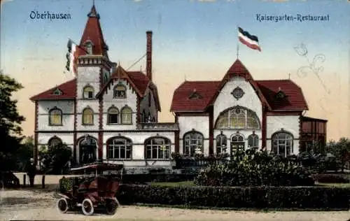 Ak Oberhausen im Ruhrgebiet,  Kaisergarten-Restaurant, Gebäude mit Fahnen, Auto