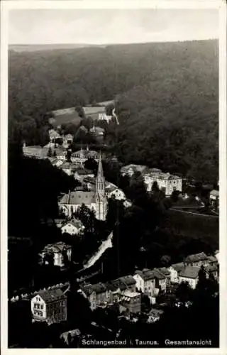 Ak Schlangenbad im Taunus Hessen, Luftaufnahme von Schlangenbad, Kirche, Häuser im Tal, Wald i...