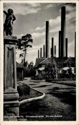 Ak Zschornewitz Gräfenhainichen in Sachsen Anhalt,  Statue, große Schornsteine, Straße, Schule