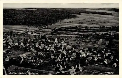 Ak Munzingen Freiburg im Breisgau, Luftaufnahme des Dorfes, zahlreiche Dächer, Landschaft im Hint