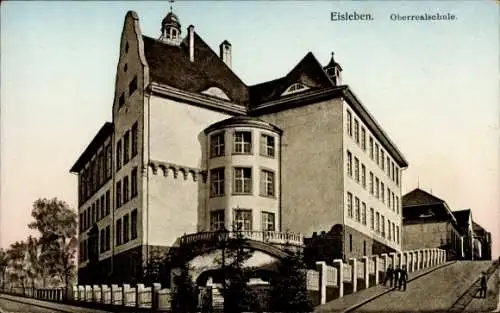 Ak Lutherstadt Eisleben, Oberrealschule,  Architektur, farbig illustrierte 